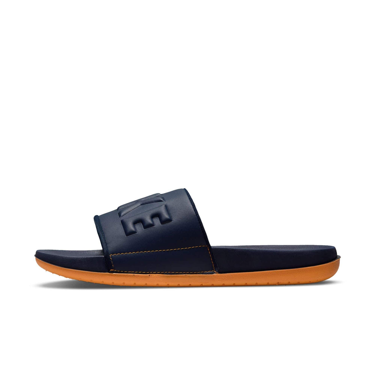 Nike Offcourt Slide sandals in navy blue with orange outsole and textured synthetic strap, side view.