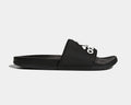 Adidas Adilette Comfort Slides in black with logo-adorned synthetic strap and cushioned footbed, side view.