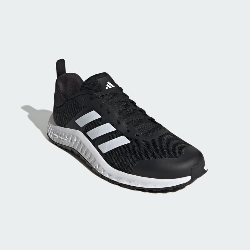 Adidas Everyset Trainer shoes in black with white accents, mesh upper, and textured midsole, front angled view.