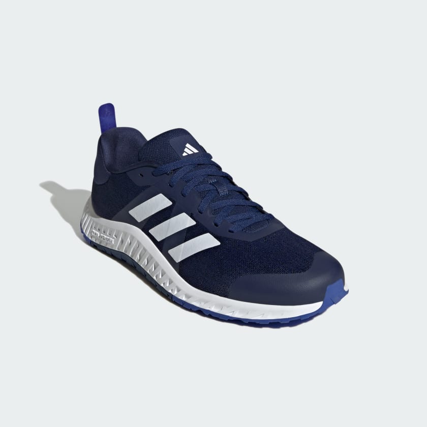 Adidas Everyset Trainer shoes in navy blue with white stripe accents, mesh upper, and textured sole, front-side view.