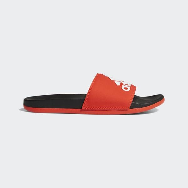 Adidas Adilette Comfort Slides in red with black sole and bold white logo on the strap, side view