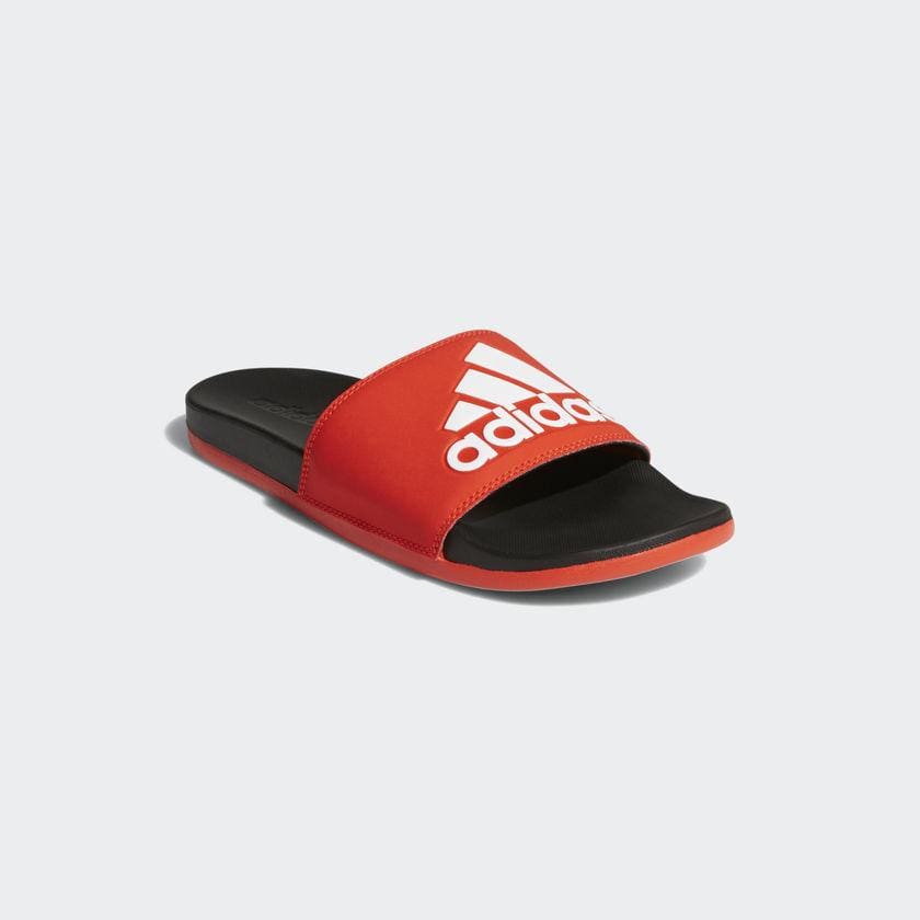 Adidas Adilette Comfort Slides in red with white logo and black cushioned footbed, angled front view.