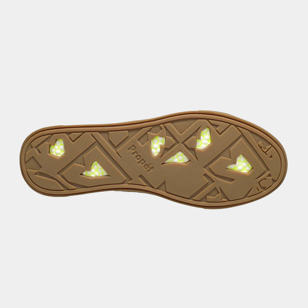 Propét Koda shoes outsole in tan with geometric tread design and green reflective accents