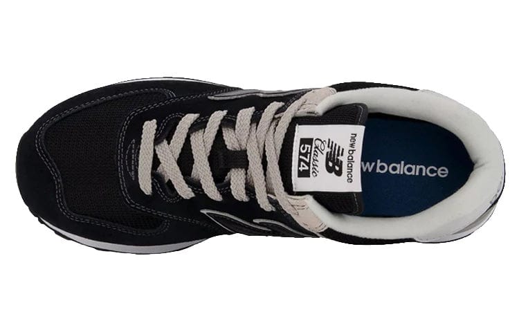 New Balance 574 Core sneakers top view showing black mesh upper, white padded collar, cream laces, and branded tongue label.