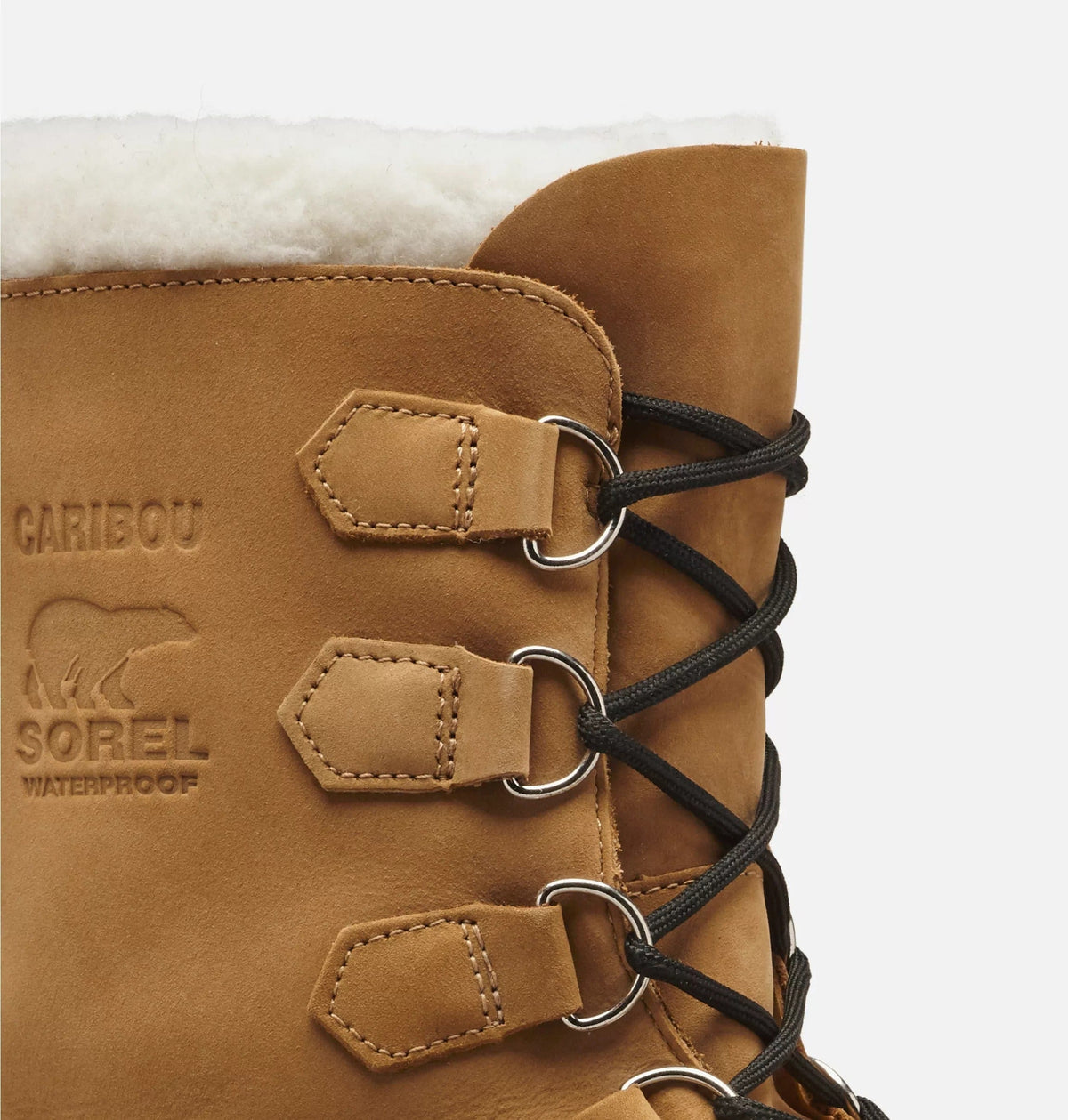 Sorel Caribou Winter Boots close-up showing waterproof tan leather upper, reinforced eyelets, black laces, and faux shearling lining.