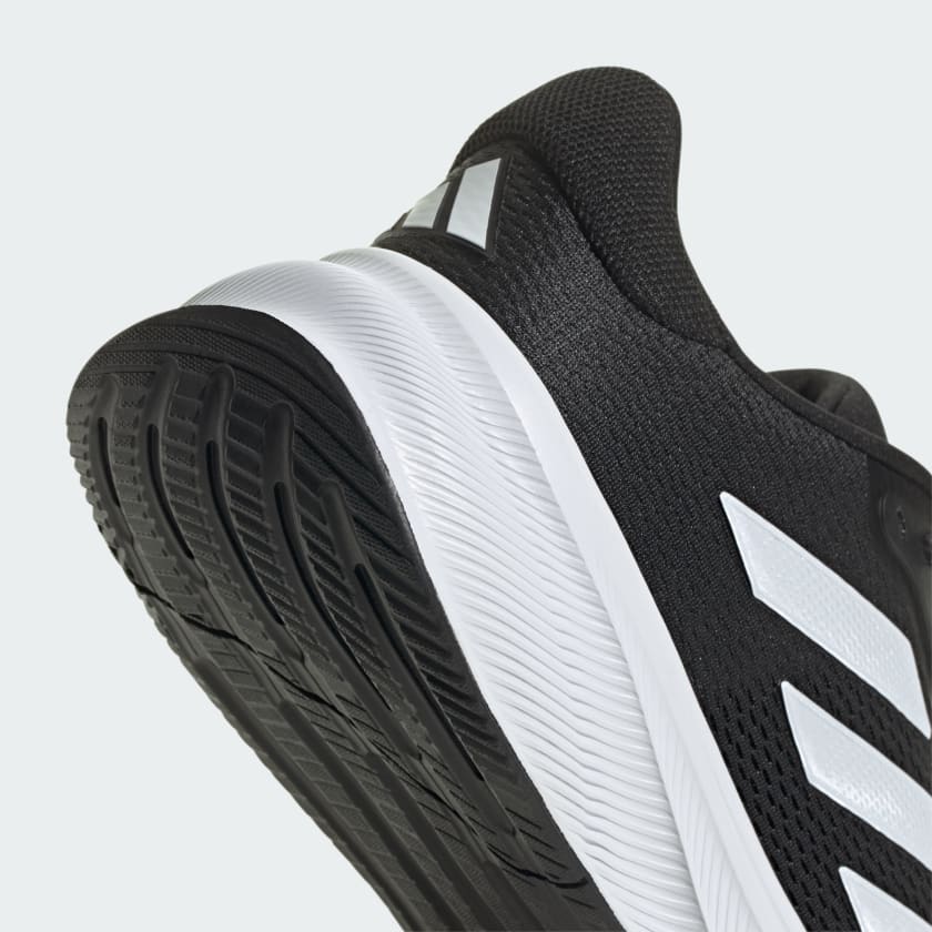 Adidas Response running shoe with lightweight black mesh upper, white midsole, and traction-enhanced black outsole, angled heel-side view.