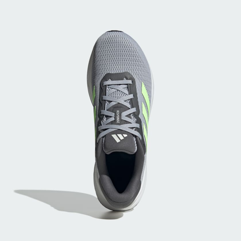 Adidas Response running shoes in gray with neon green accents and breathable mesh upper, top view showing lace system and logo detail.