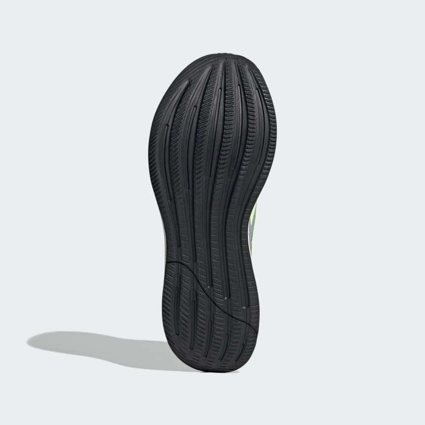 Adidas Response running shoes outsole in black rubber with durable tread pattern and flex grooves, bottom view.