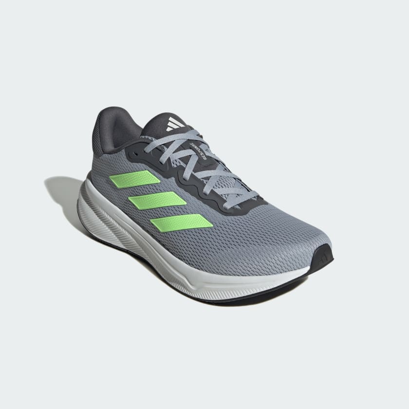Adidas Response running shoes in gray with neon green stripes and breathable mesh upper, angled front side view.