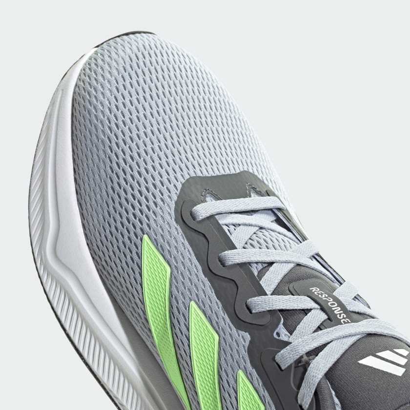 Adidas Response running shoes in gray with breathable mesh upper, lime green accents, and lace system, top view.