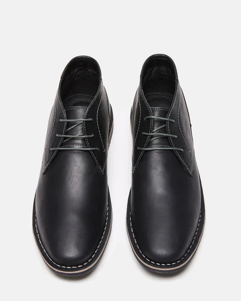Steve Madden Harken dress boots in black leather with stitched detailing and round toes, top view showing lace-up design.