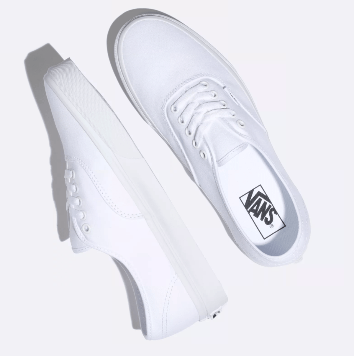 Vans Authentic sneakers in pristine white with canvas upper, metal eyelets, and vulcanized rubber sole, top and side views.