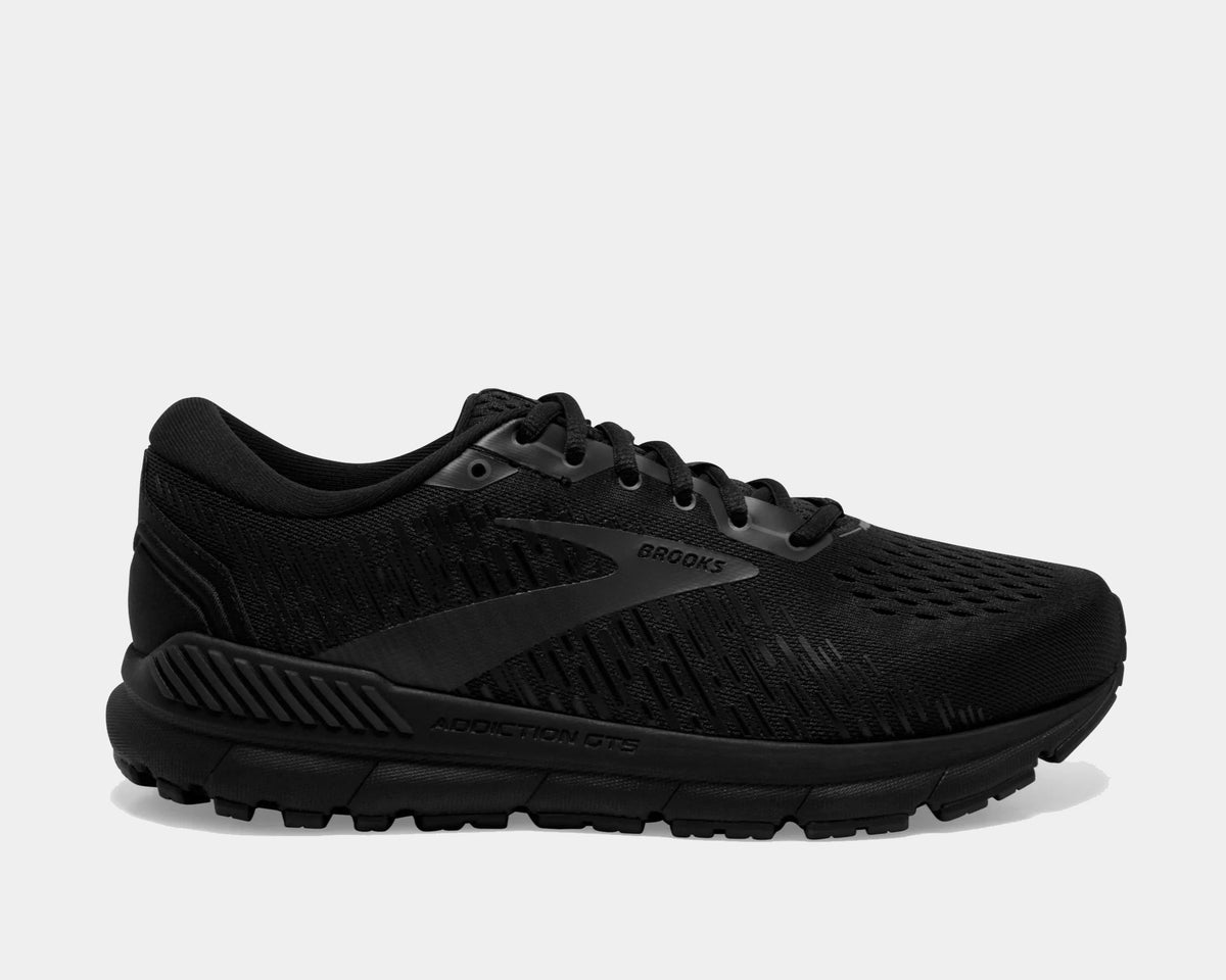 Brooks Addiction GTS 15 running shoes in black with engineered mesh upper, GuideRails support system, and cushioned sole, side view.