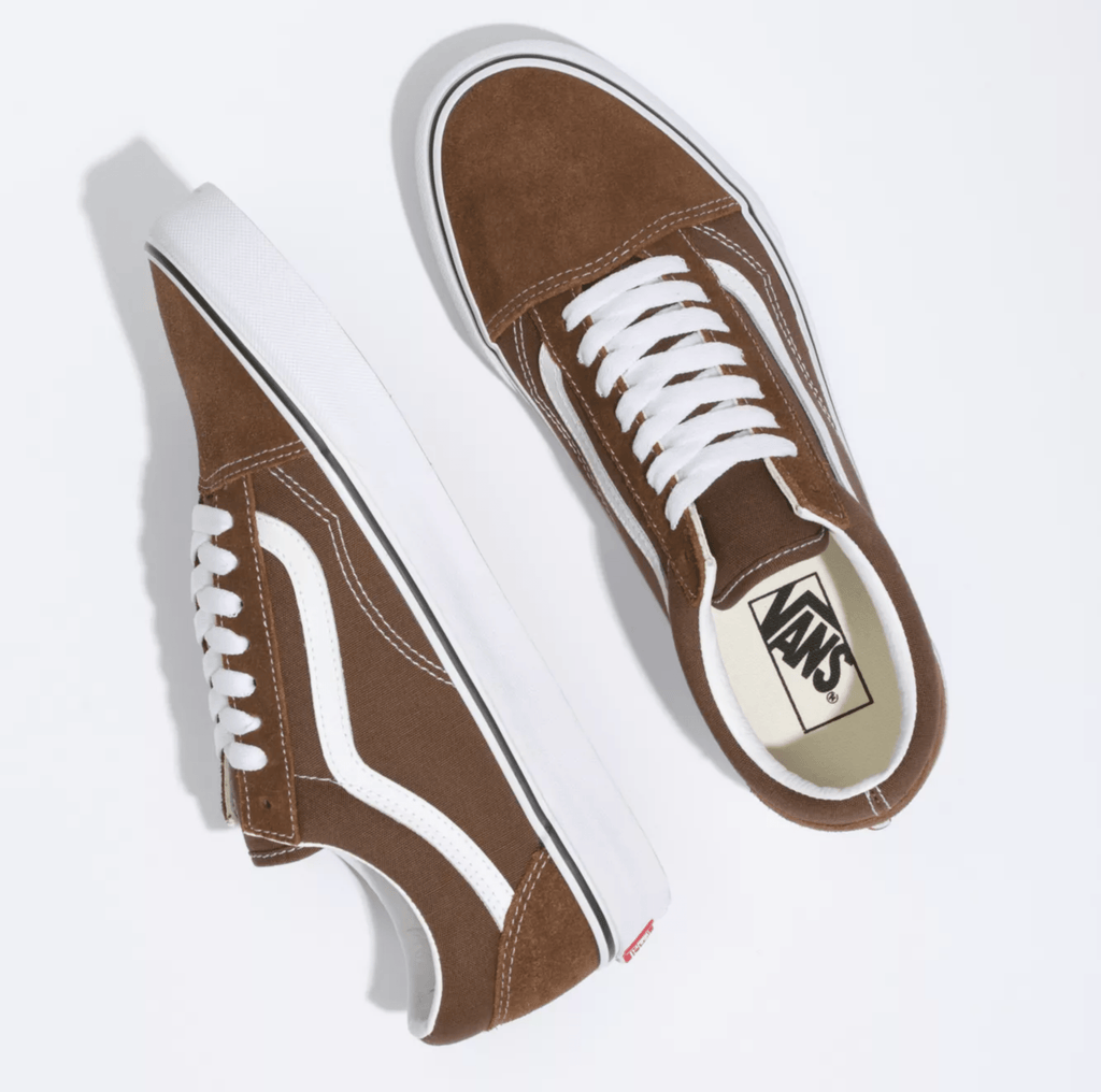 Vans Old Skool sneakers in brown with white suede and canvas upper, signature side stripe, and white rubber outsole, top view.