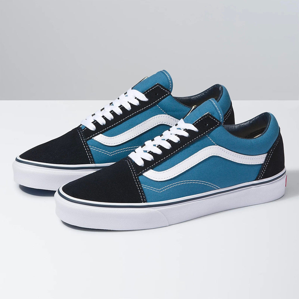 Vans Old Skool sneakers with a blue canvas upper, black suede overlays, white jazz stripe, and white rubber sole, side view.