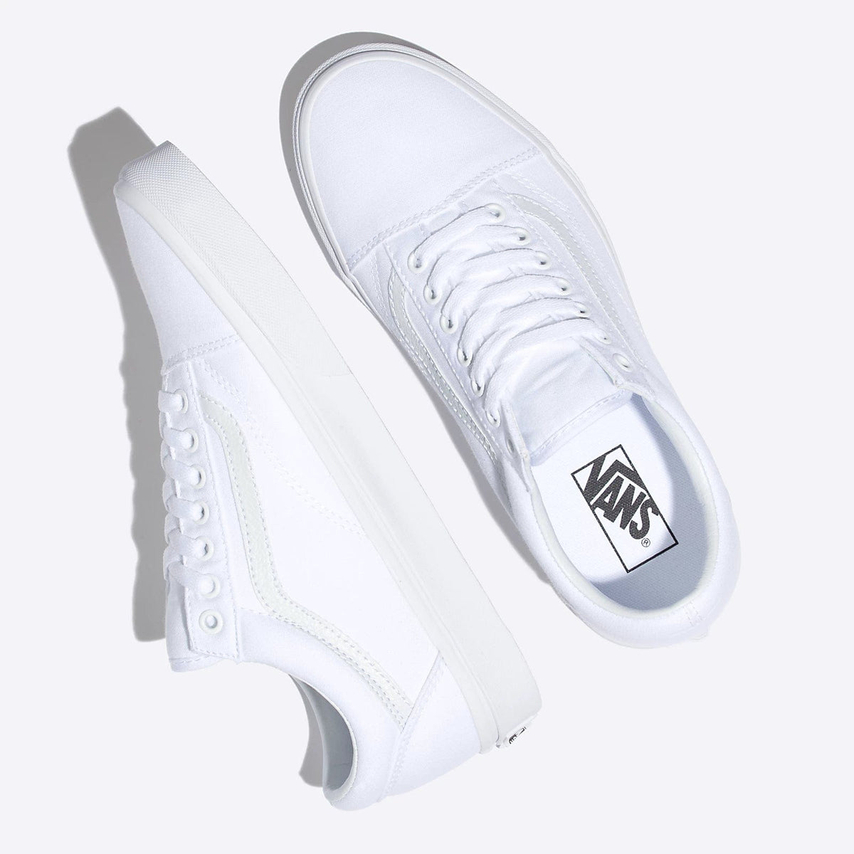 Vans Classic Old Skool sneakers in white with canvas upper, suede accents, and lace-up design, top angle view.