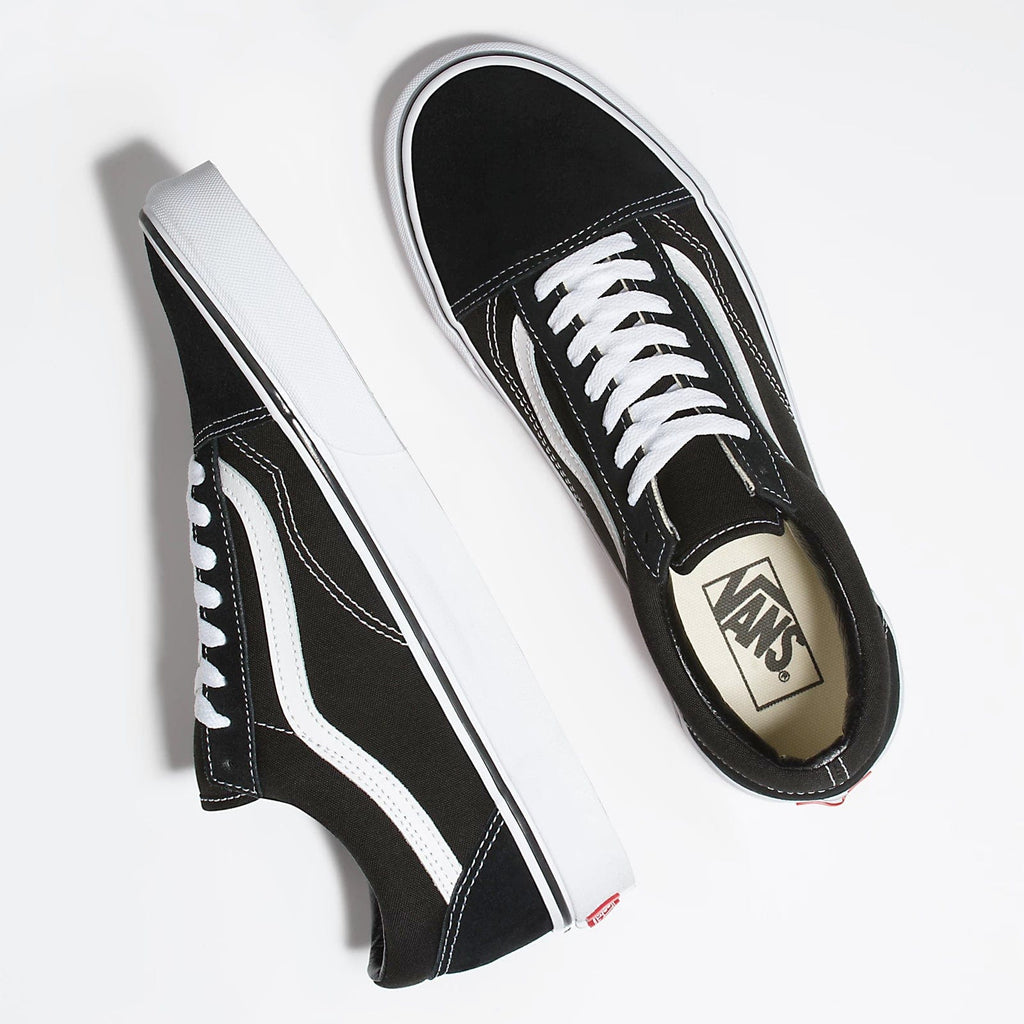 Vans Classic Old Skool sneakers in black with white side stripe, canvas upper, padded collar, and white laces, top view.