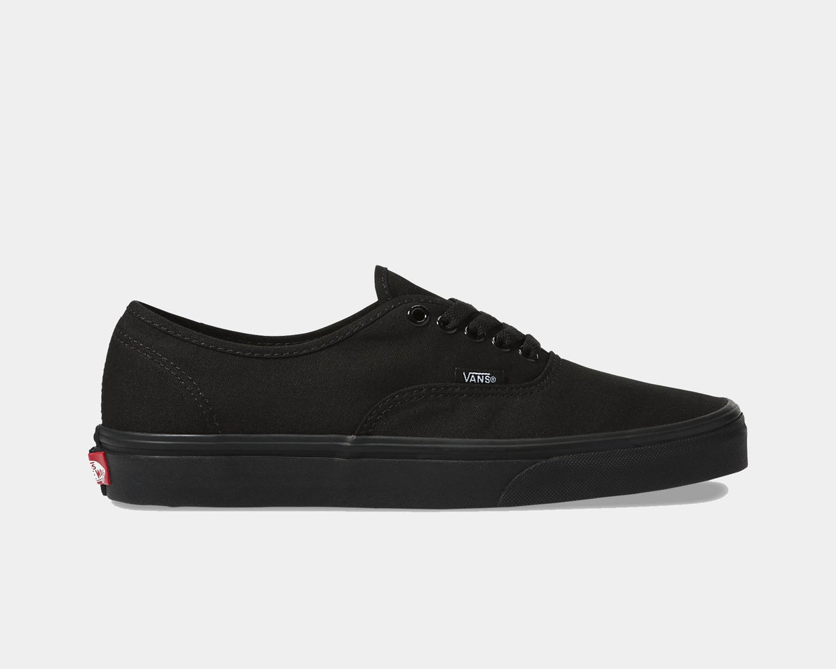 Vans Authentic sneakers in solid black canvas with matching black rubber sole and metal eyelets, side view.
