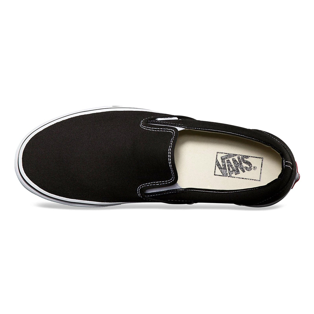 Vans Classic Slip On shoes in black canvas with white stitching and Vans logo on cushioned insole, top view.