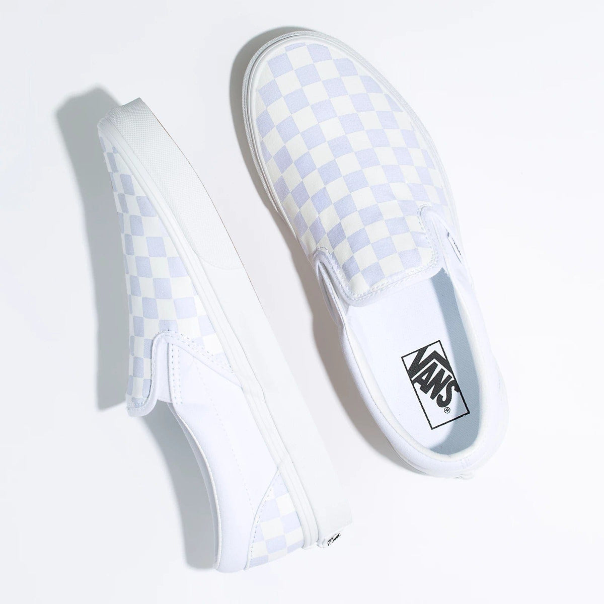 Vans Checkerboard Slip On shoes, white canvas with light blue checkered pattern, elastic side accents, top view.