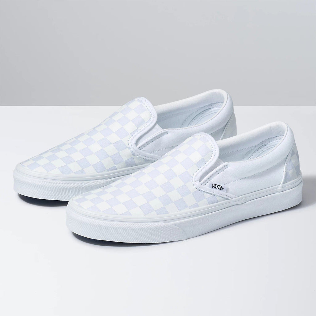 Vans Checkerboard Slip On shoes in white with classic checkerboard pattern and rubber outsole, angled side view.