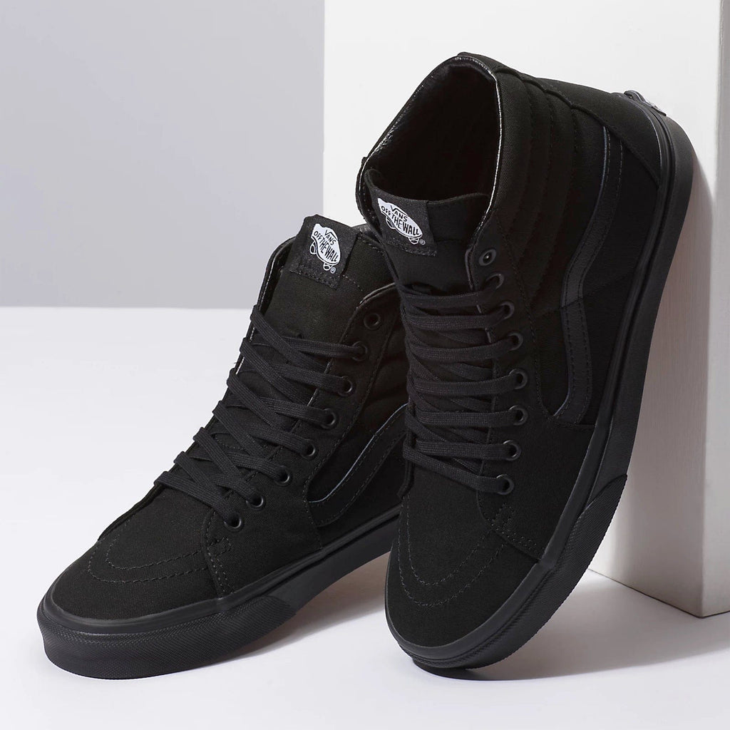 Vans Sk8-Hi high-top sneakers in black canvas with padded collars and signature side stripe, front and angled view.