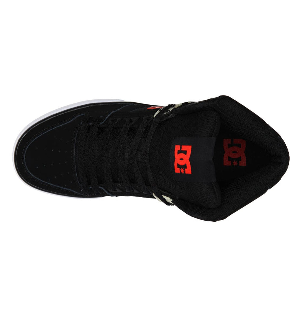 DC Footwear Pure High Top WC sneakers top view showcasing black uppers, perforated toe box, and red DC branding on the tongue.