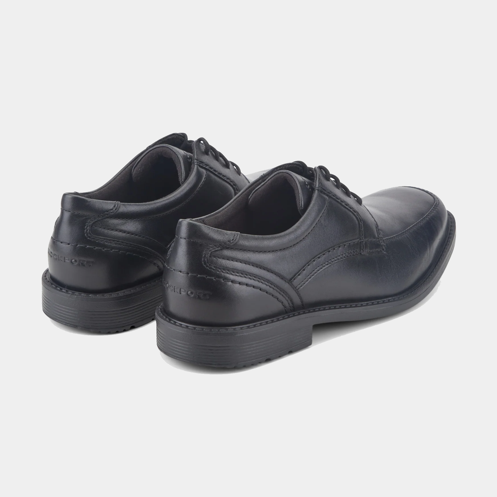 Rockport Style Leader 2 Apron Toe dress shoes in black leather with apron toe design and embossed branding, back angle view.