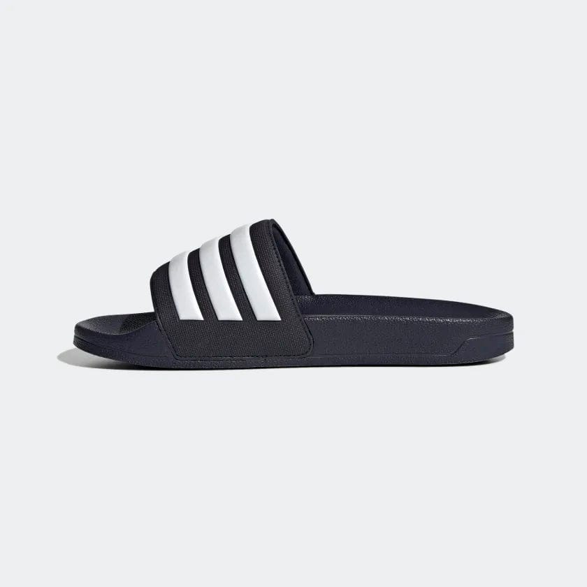 Adidas Adilette Shower Slides in navy blue with white striped band, side profile view.