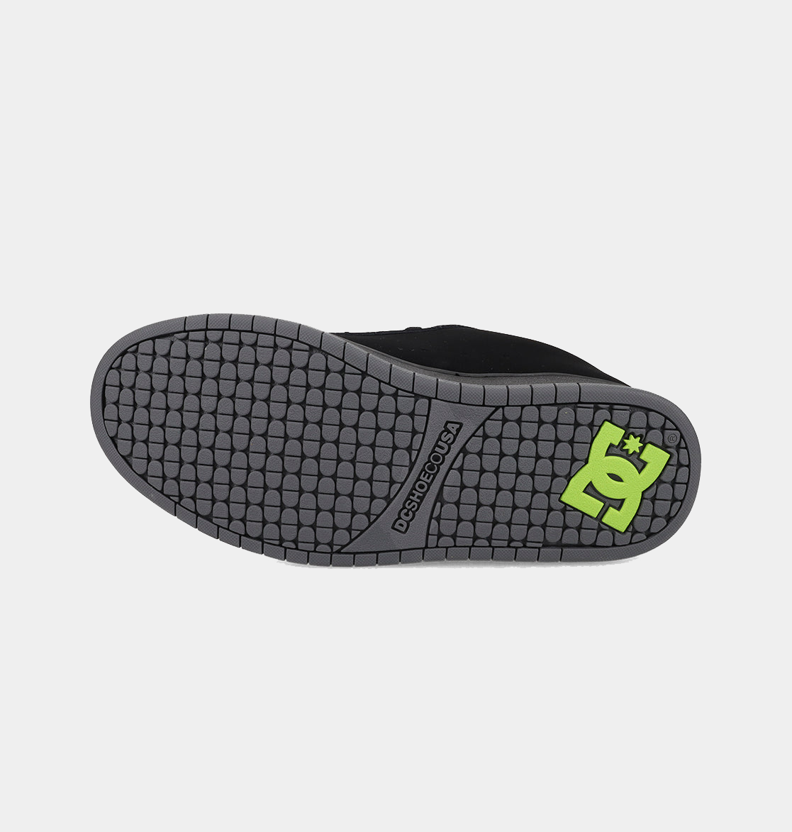 DC Footwear Court Graffik skate shoes outsole in gray rubber with textured tread pattern and green DC logo, bottom view.
