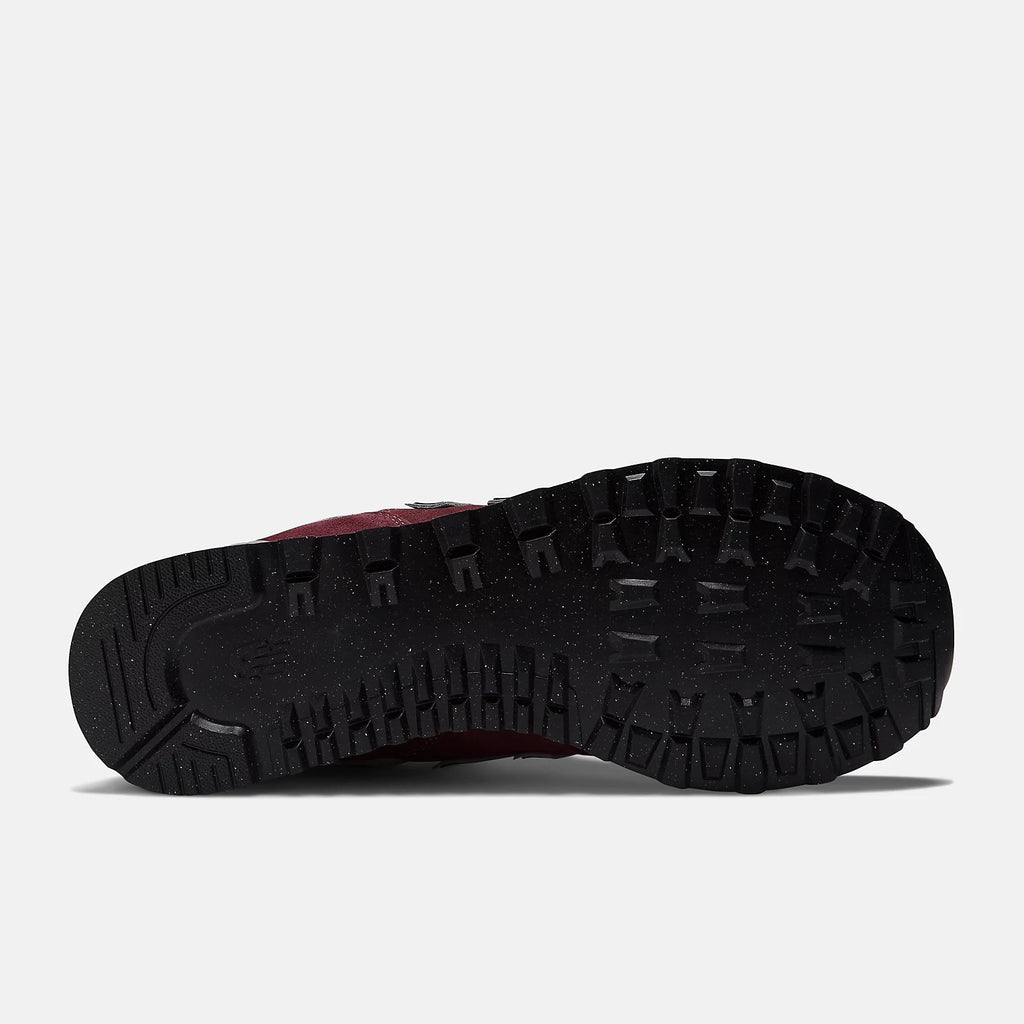 New Balance 574 Core sneakers outsole featuring black rubber with rugged tread pattern for traction, sole/bottom view.