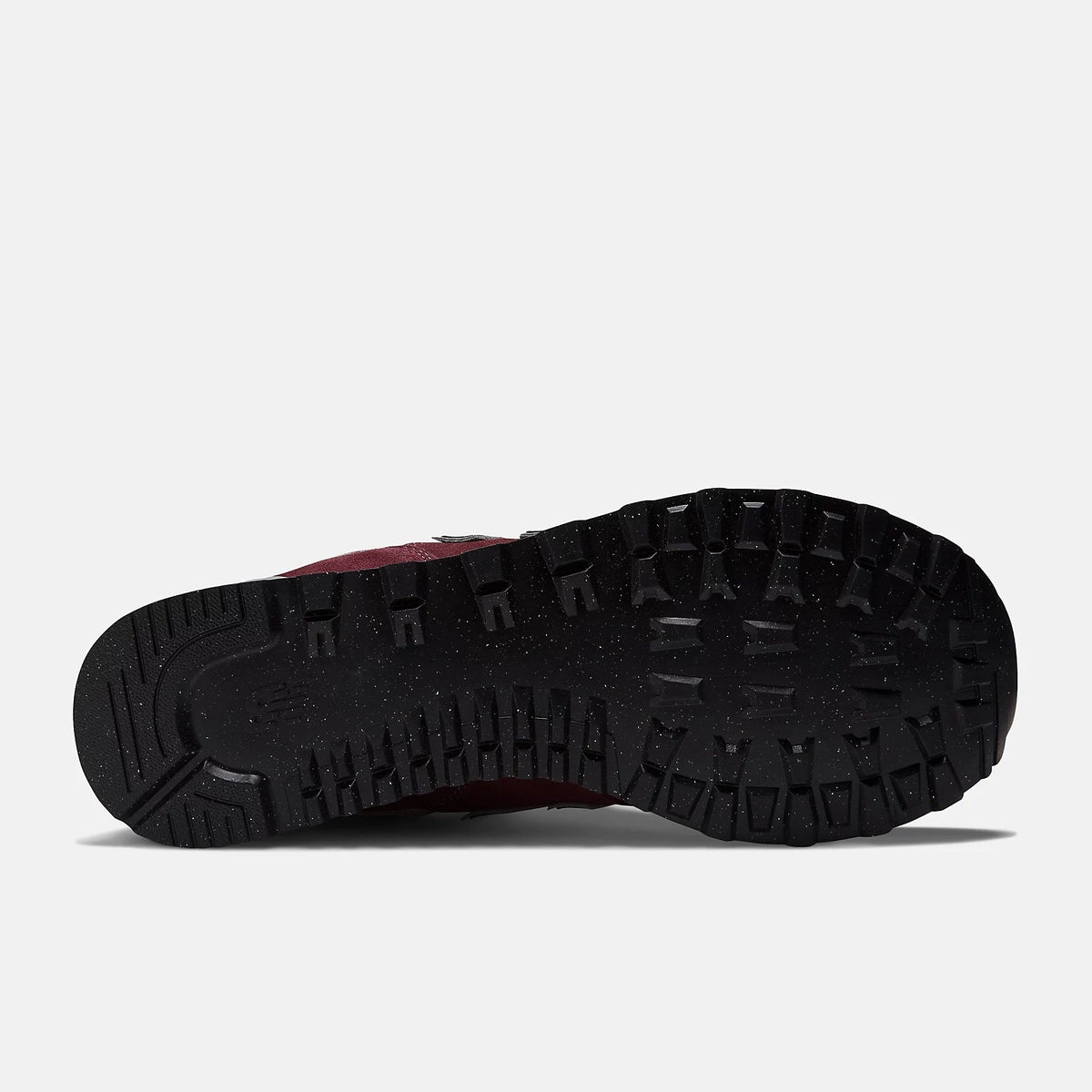 New Balance 574 Core sneakers outsole featuring black rubber with rugged tread pattern for traction, sole/bottom view.