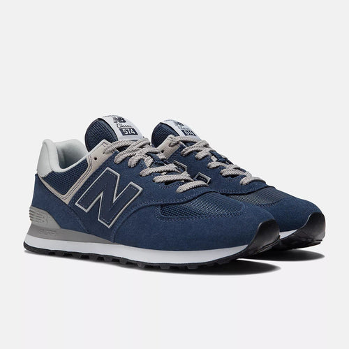 New Balance 574 Core sneakers in navy suede and mesh with gray accents and lace-up closure, angled front view.