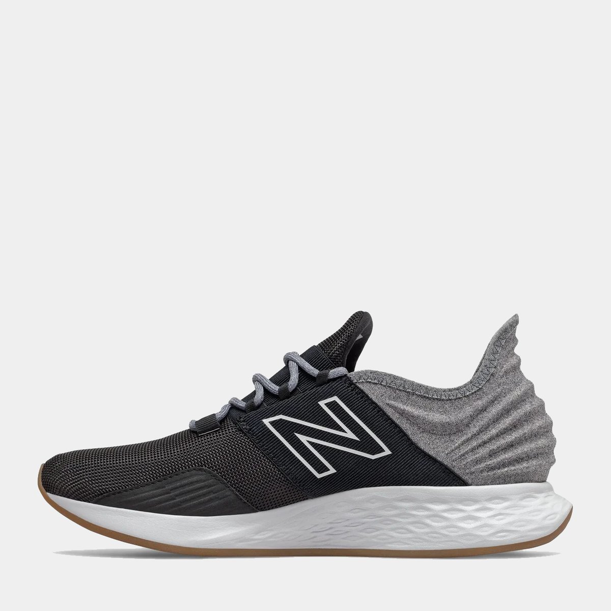 New Balance Fresh Foam Roav Tee Shirt running shoes in black and gray with a mesh upper, Fresh Foam midsole, and gum outsole, side view.