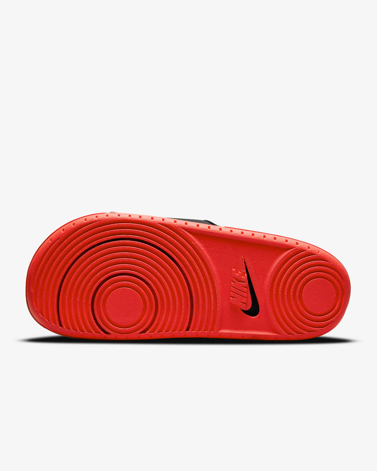 Nike Offcourt Slide sandals outsole in bright red featuring circular tread patterns and black logo detailing, sole/bottom view.