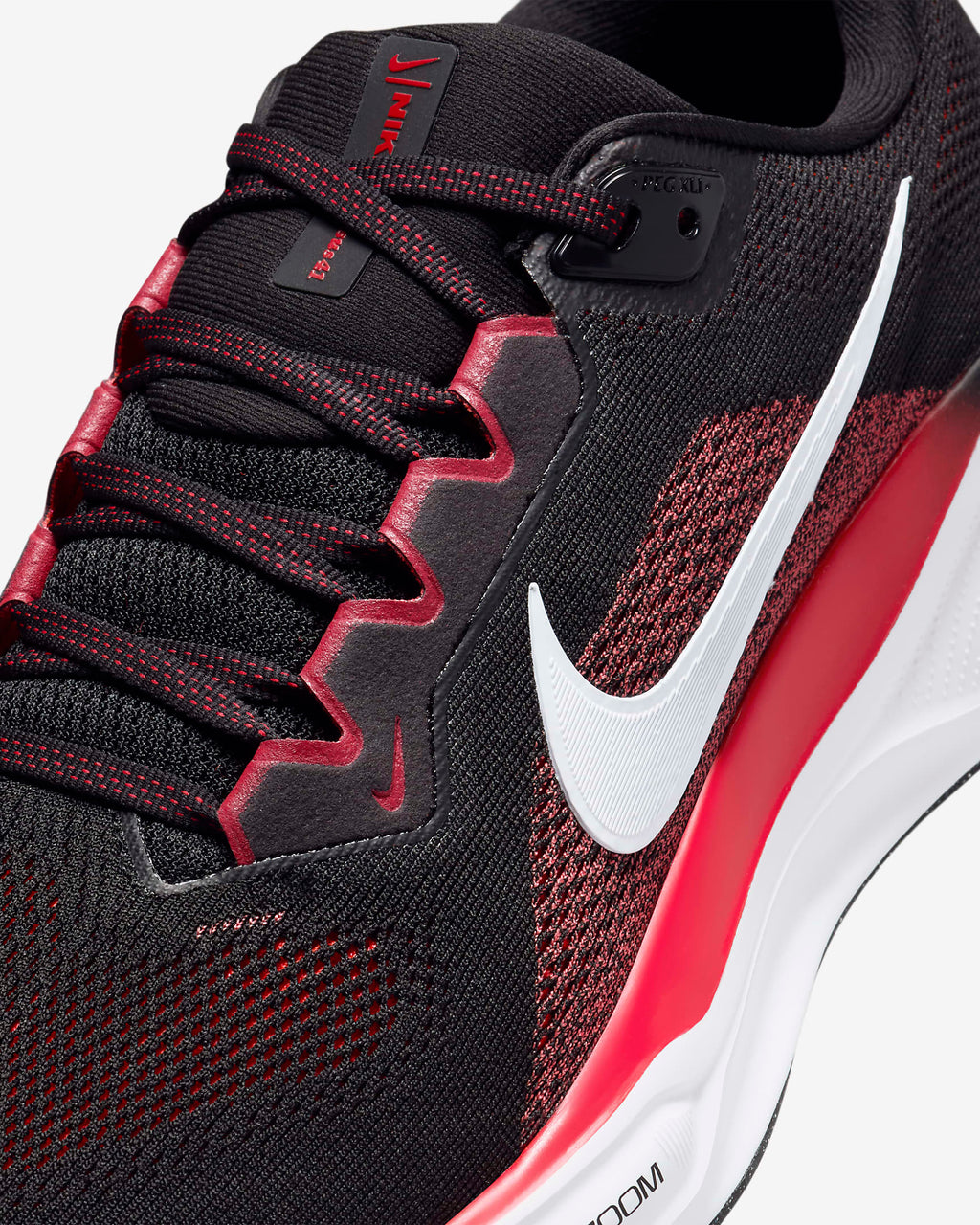 A pair of black Nike Air Zoom Pegasus 41 running shoes with white and red accents .